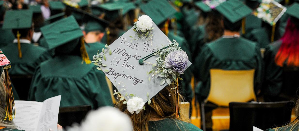 Graduation cap with a quote and flower decorations