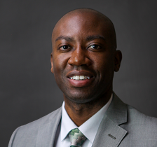 Head shots to Andrew Wingard wearing a light gray suit, with a white shirt and a green tie. 
