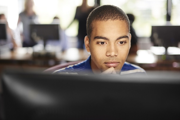 Student sitting at computer monitor 