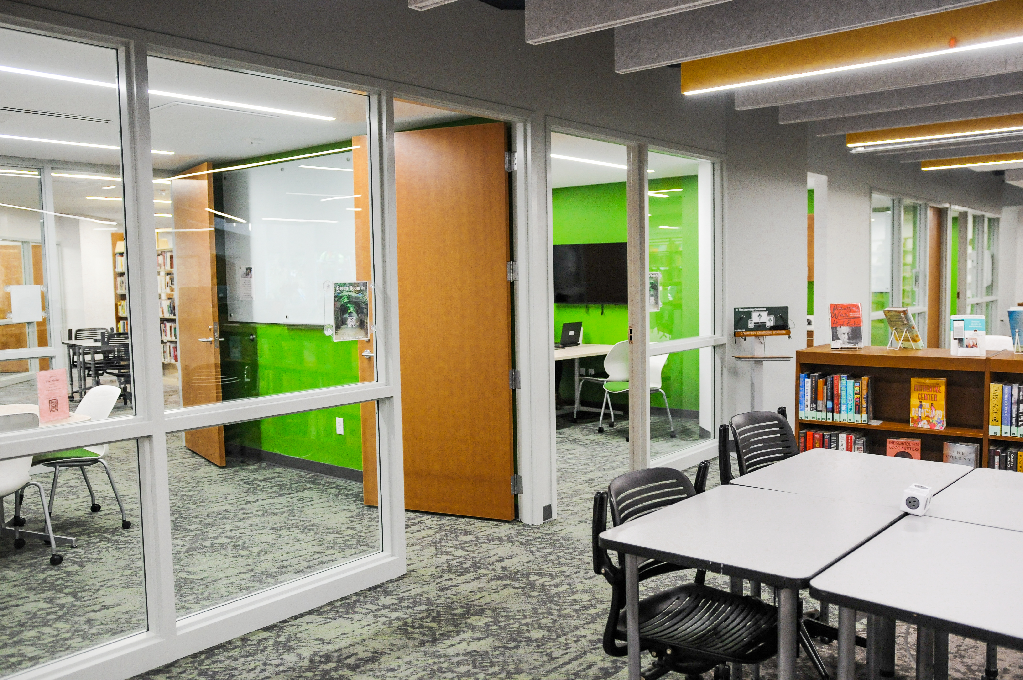 Student in library at table with laptop and headphones