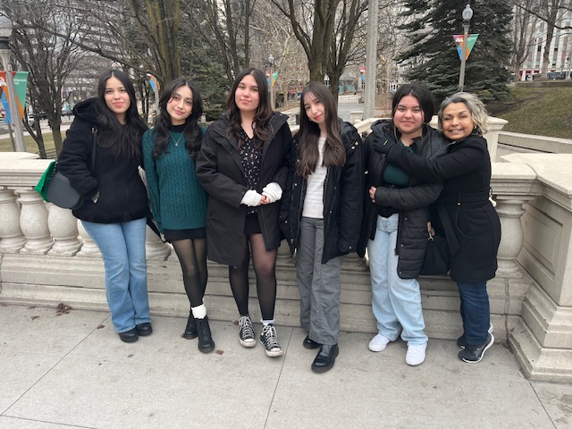 Group of students from the Hispanic Student Alliance standing outside in the winter in the city of Chicago.
